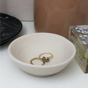 This is a plate for jewelry made out of clay.